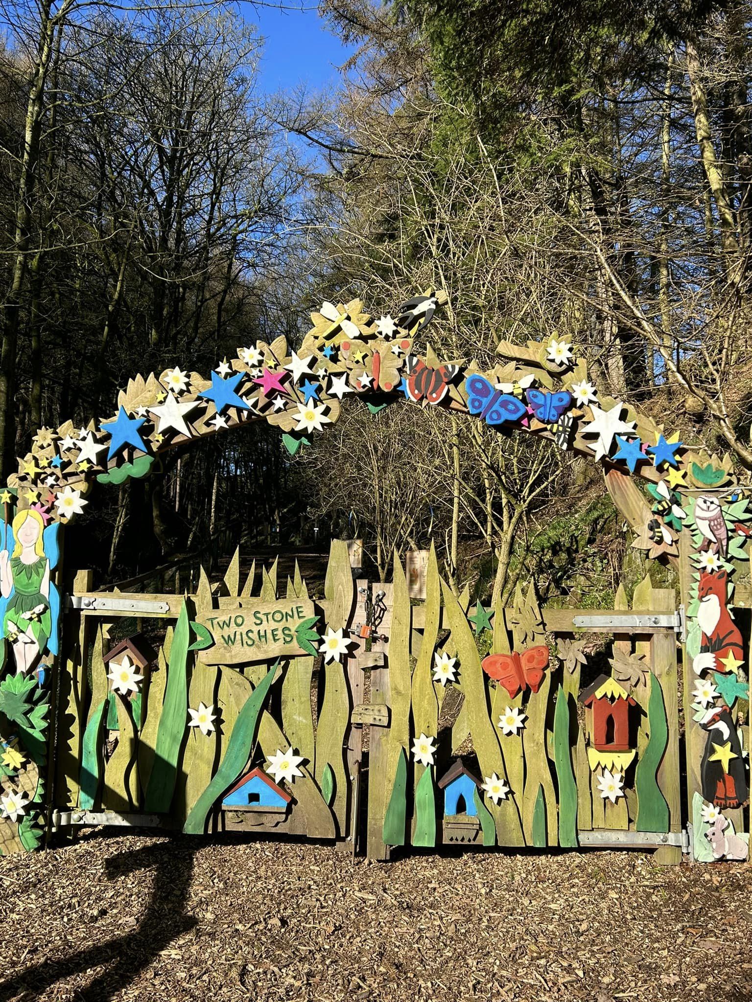 Wooden archway with nature motifs at Studfold Trail