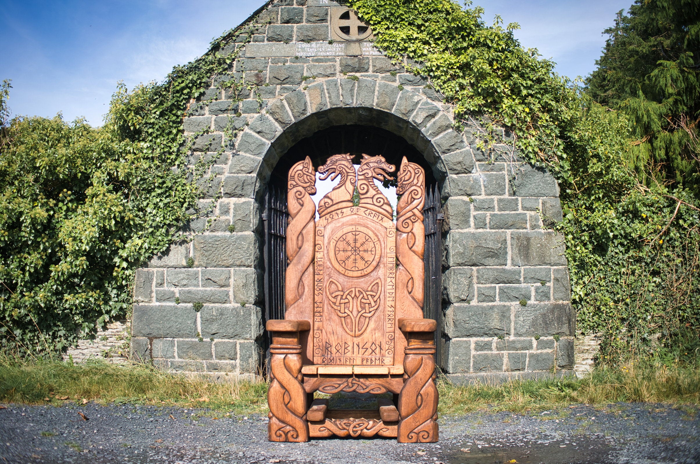 Viking Throne Chair in front of stone gate