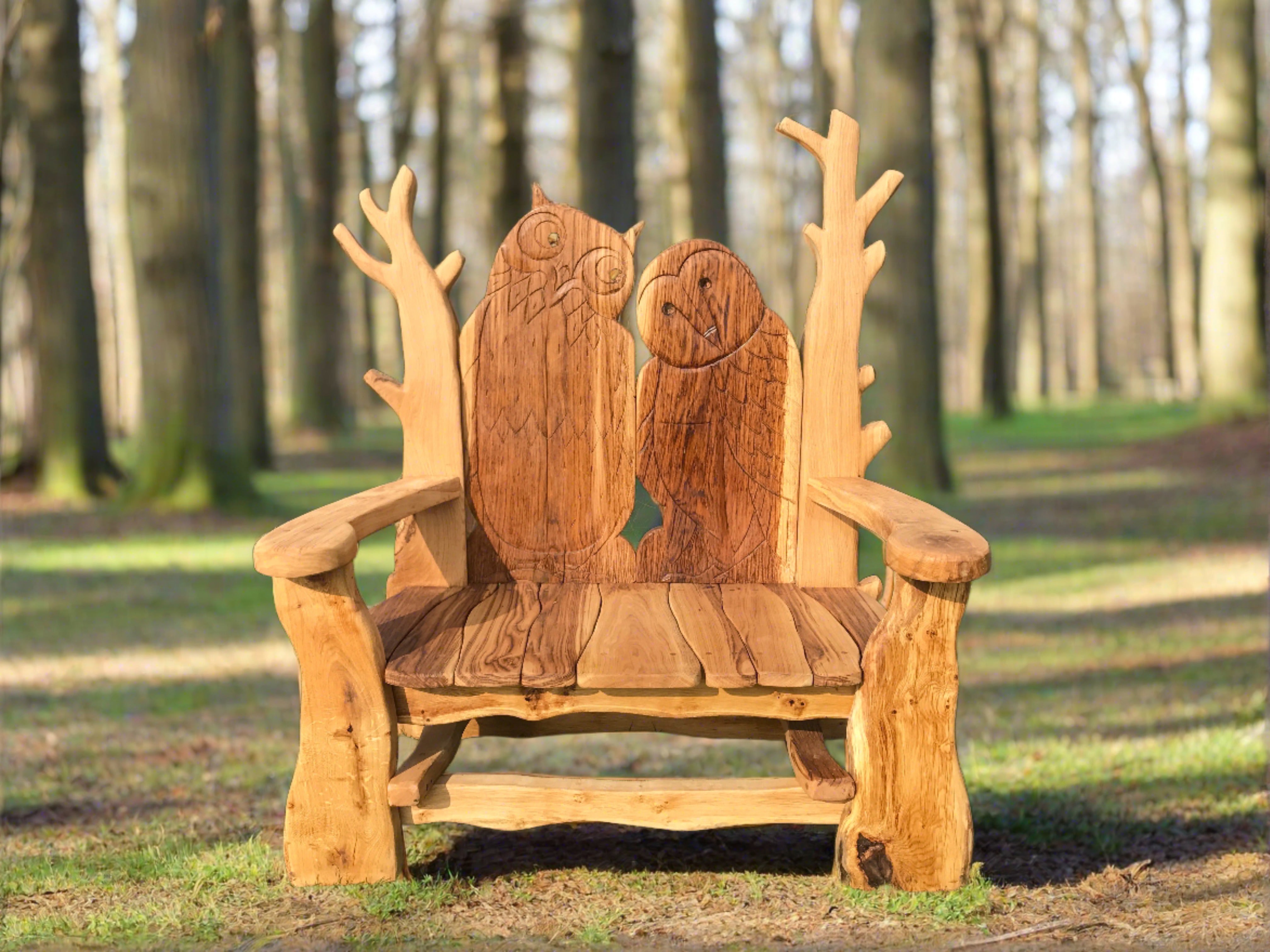 Rustic wooden bench with owl carvings in a wooded area.