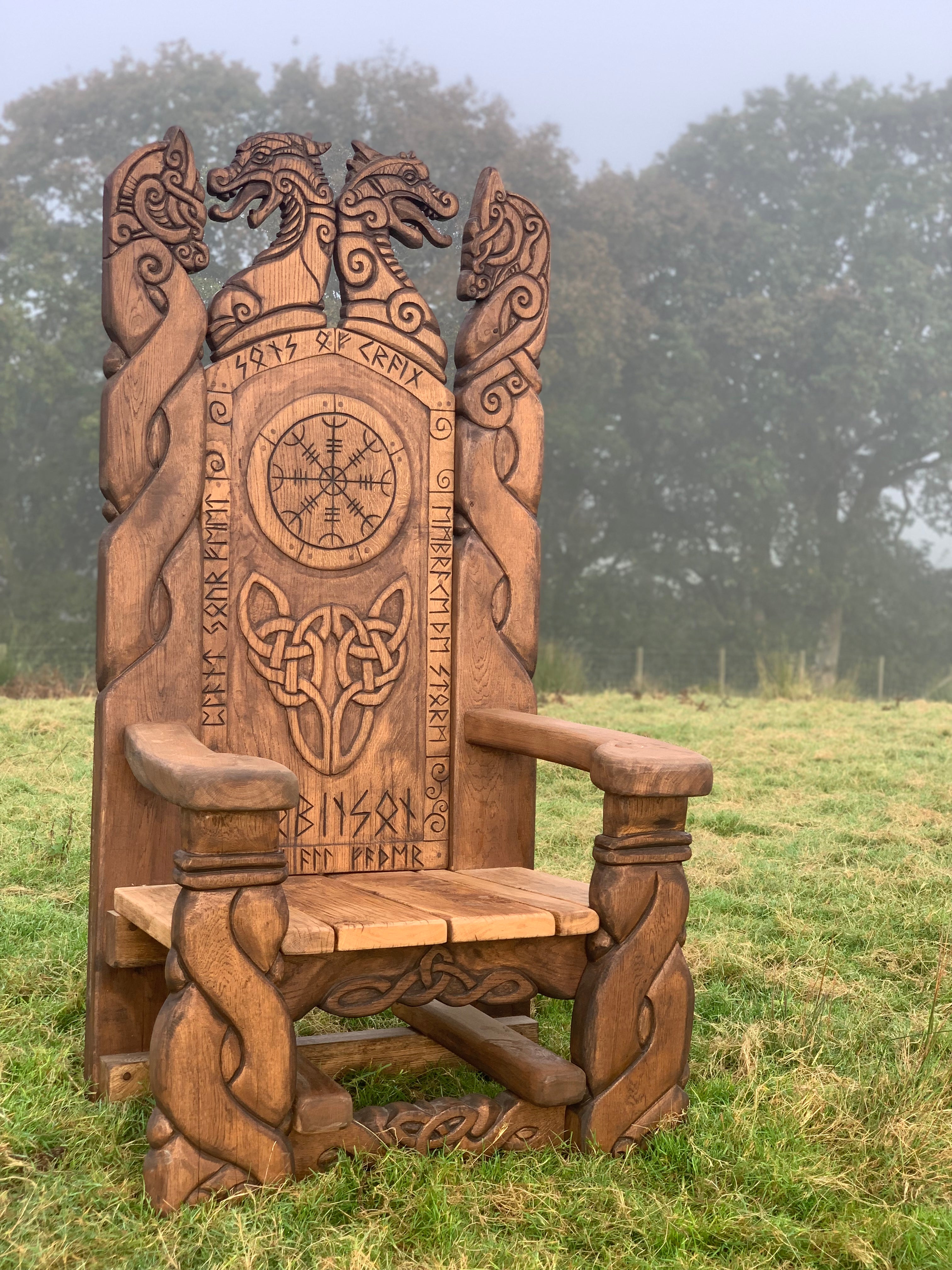 Viking throne in misty field with carvings