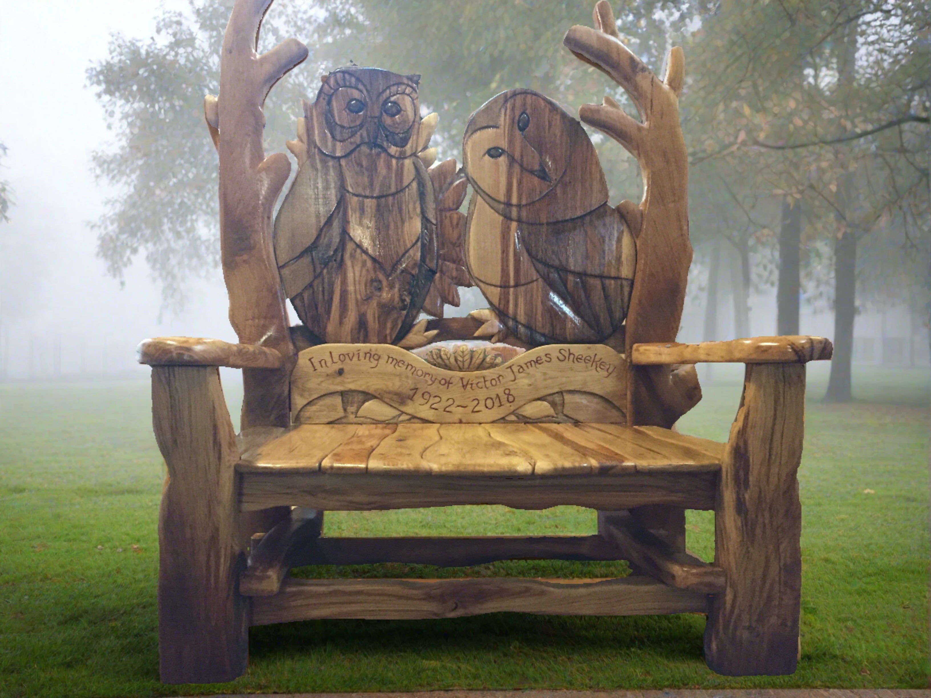 Owl-themed memorial bench in misty park