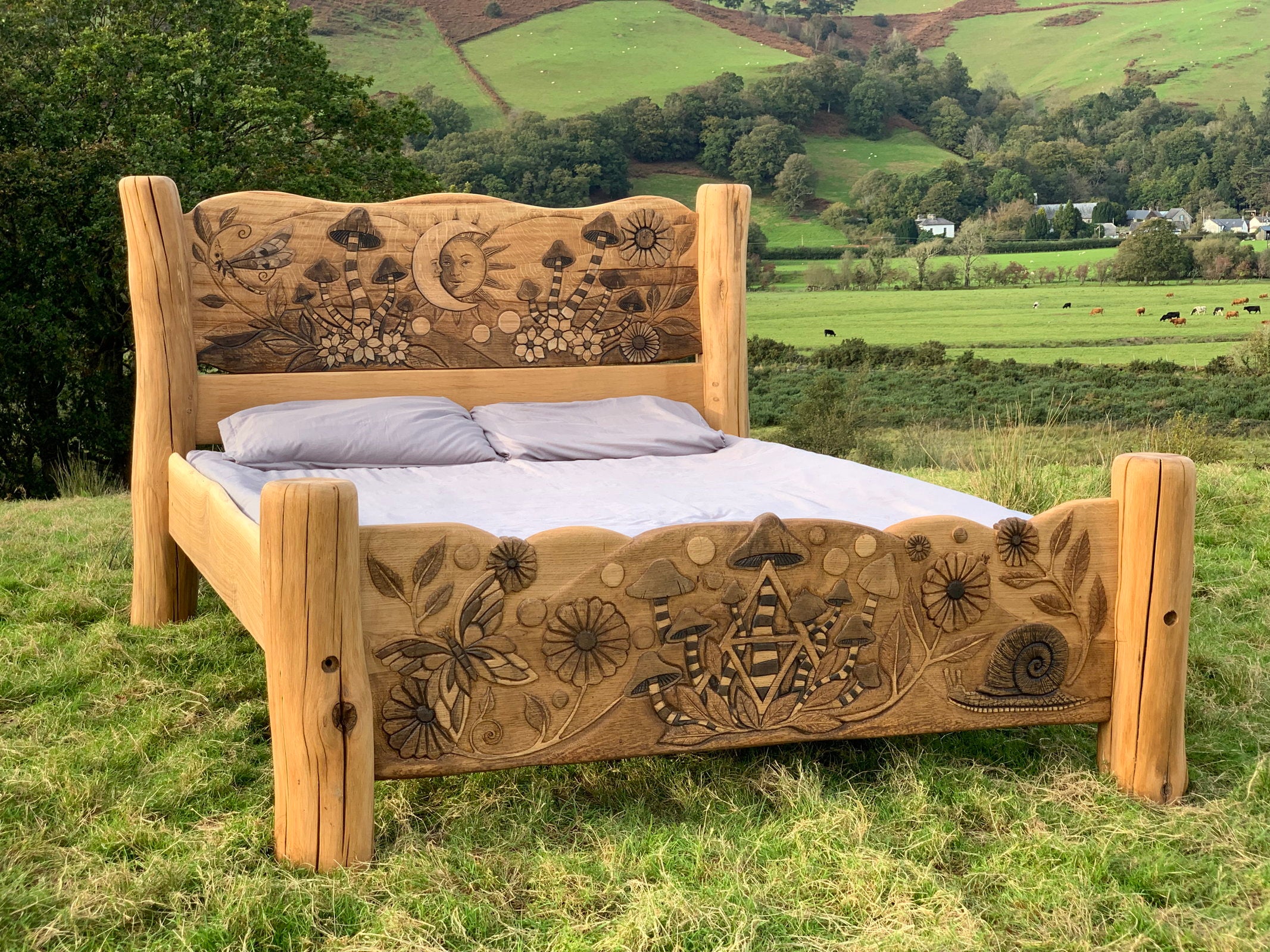 Rustic oak bed with nature carvings in scenic landscape