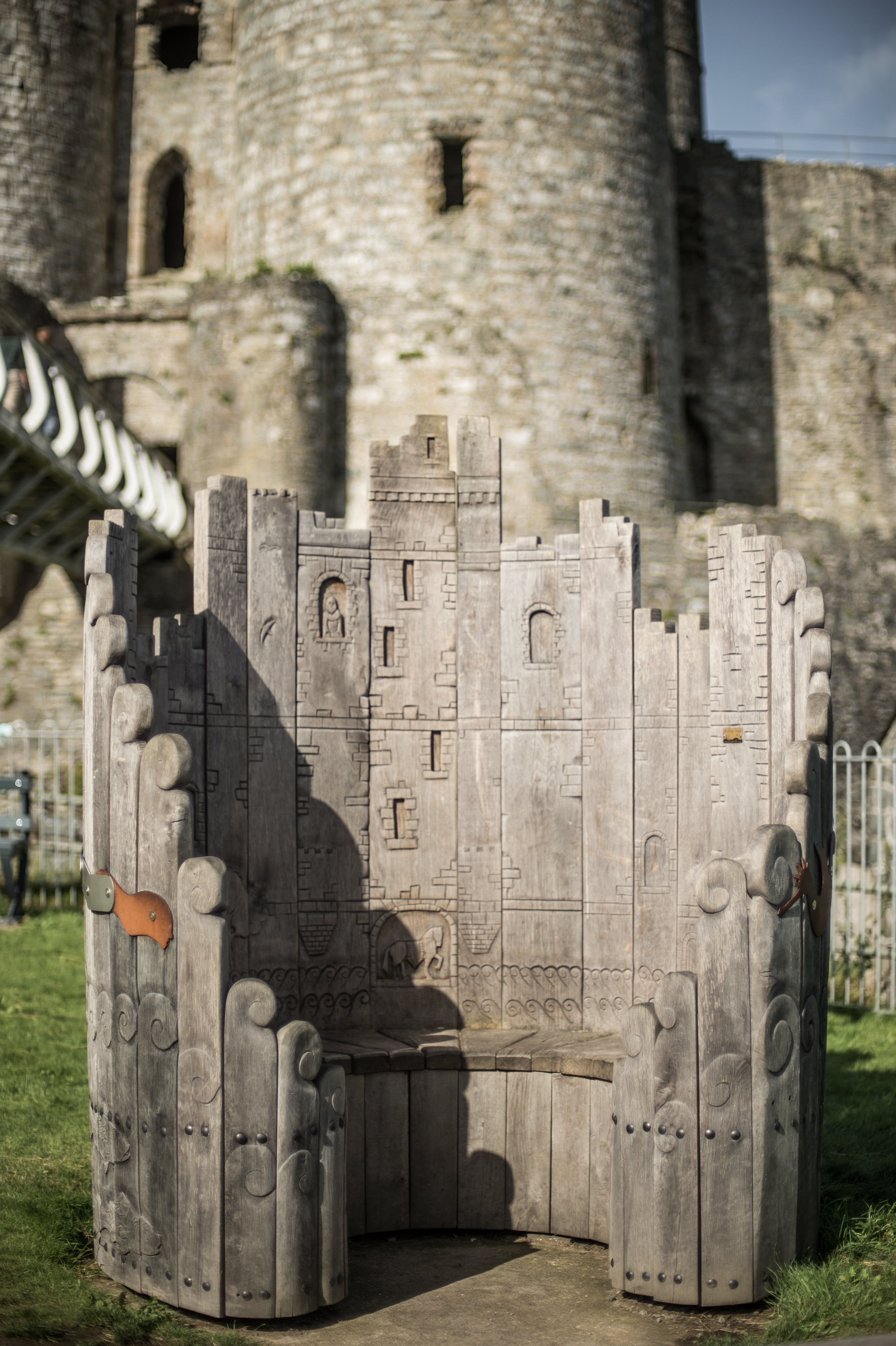 Circular wooden bench with castle carvings