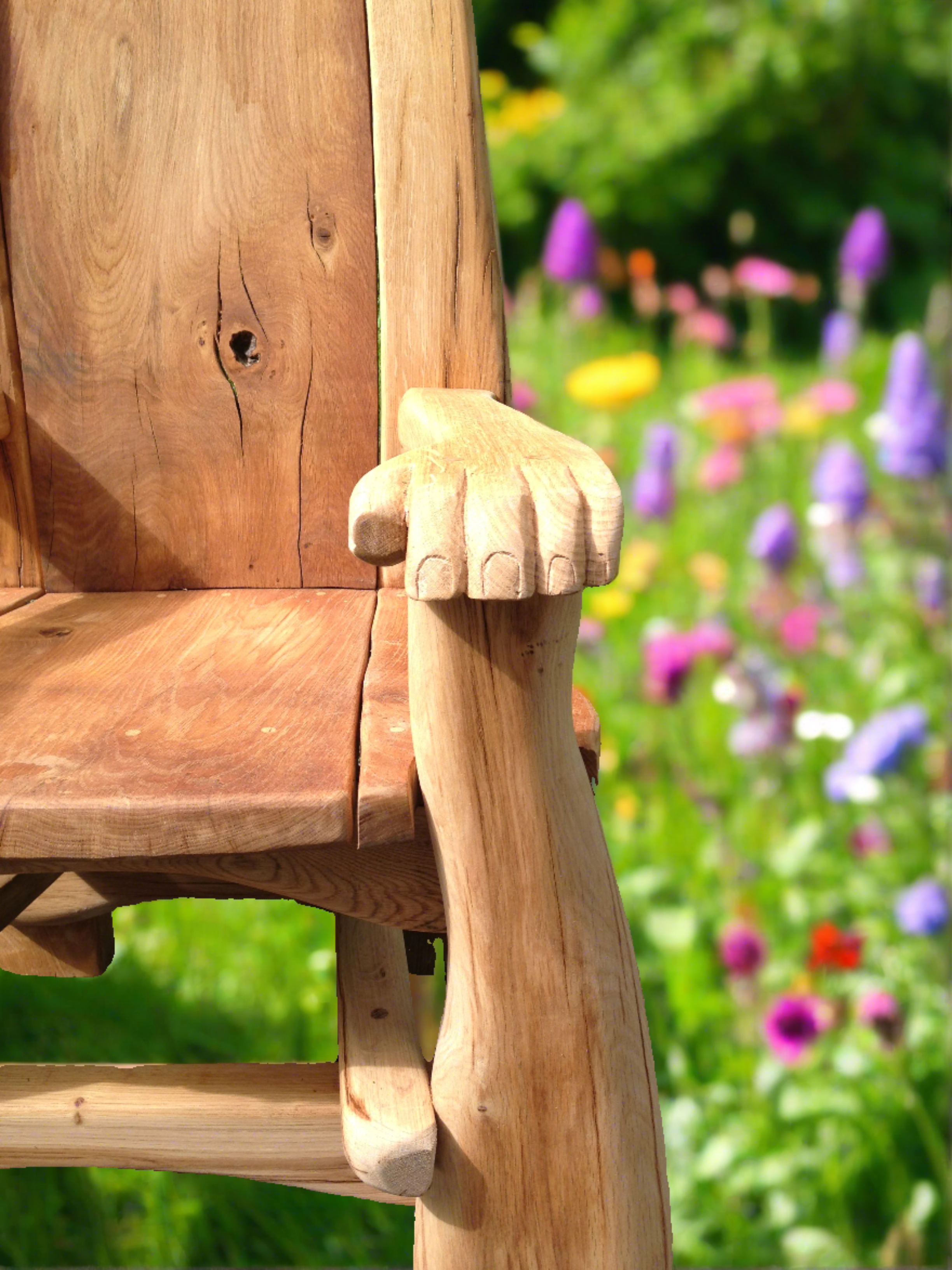 Close-up of wooden chair armrest in garden