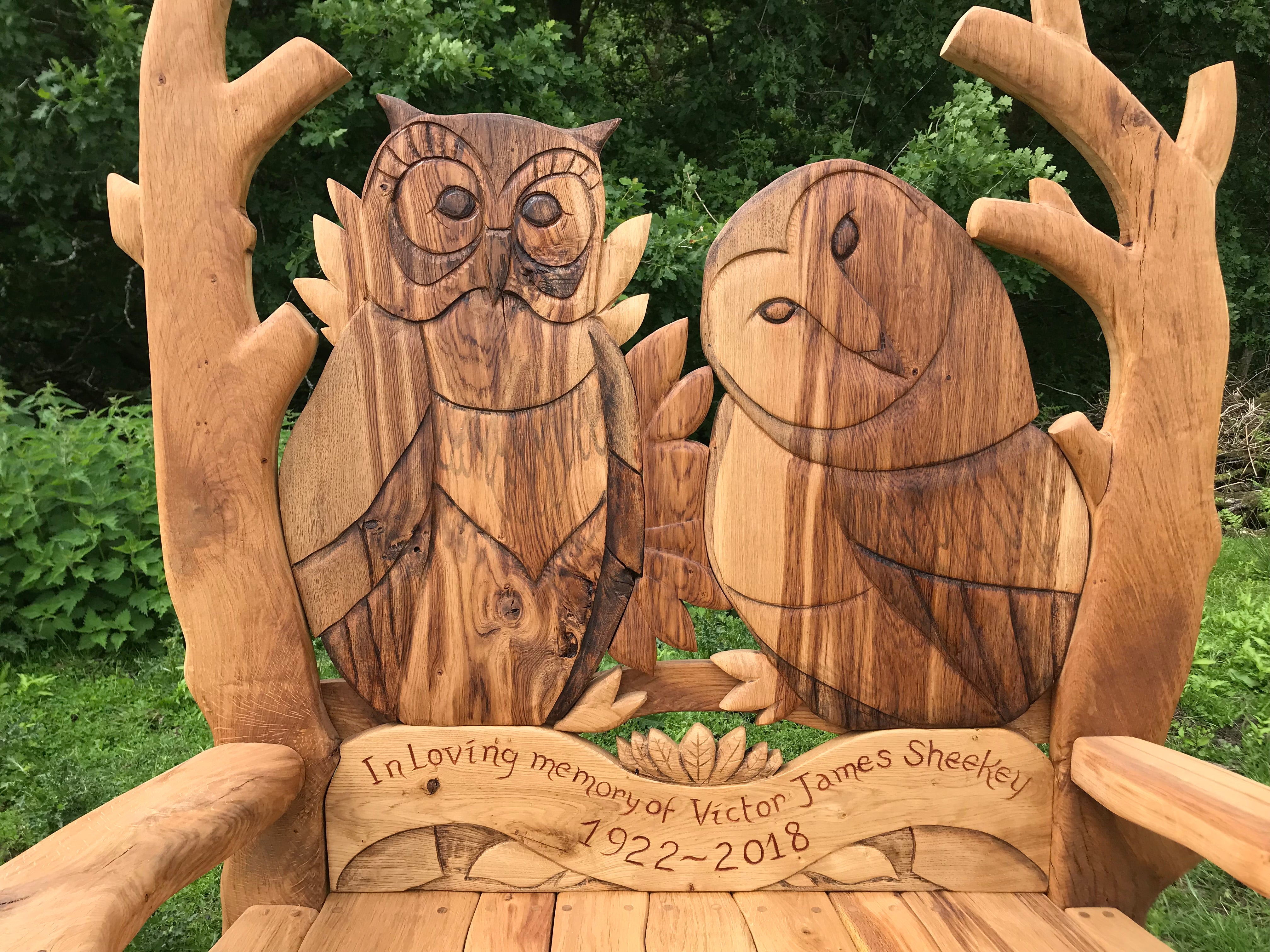 Hand-carved wooden bench with owl and owl design.