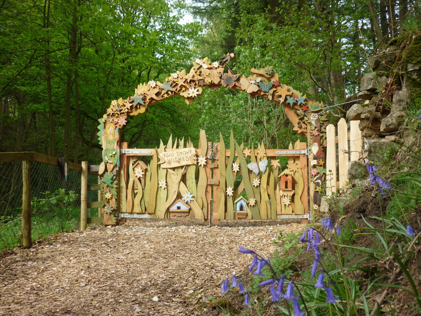 Fairy-themed archway with flowers at Studfold Trail