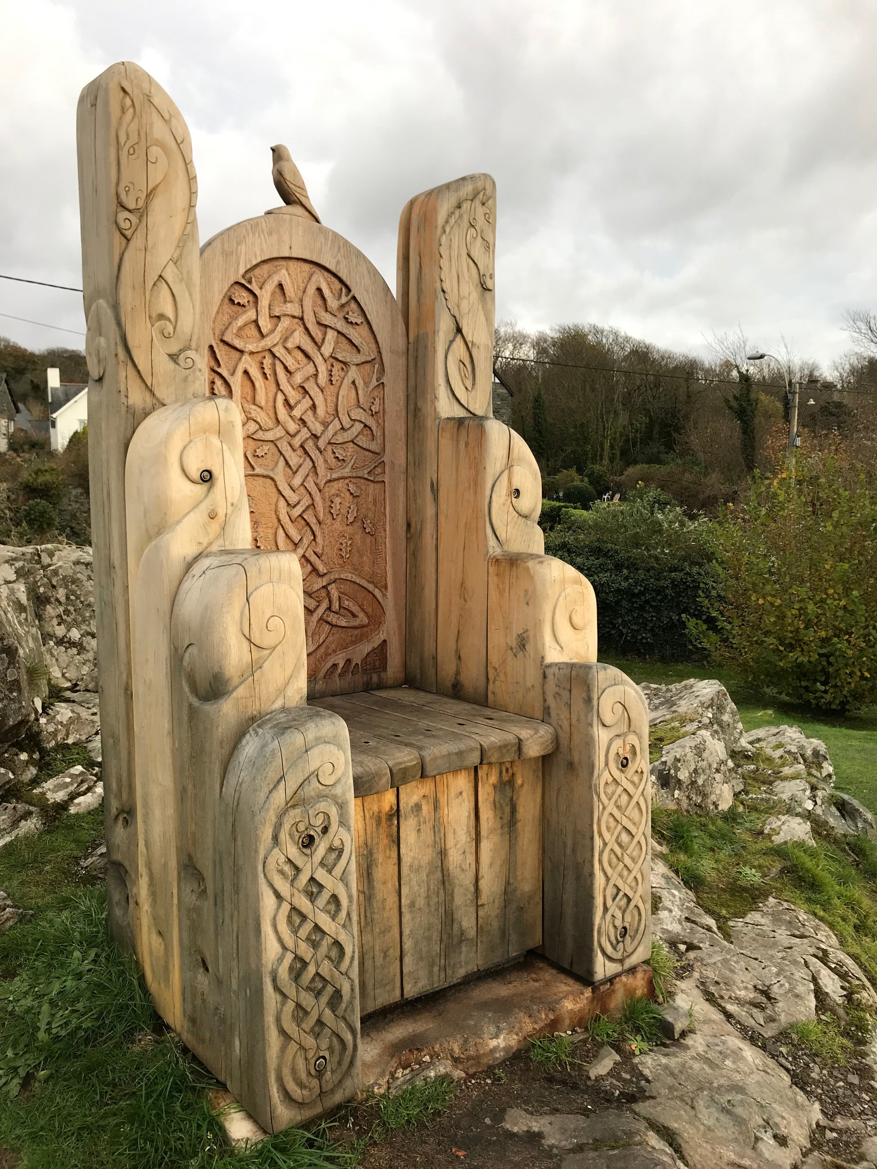 Three wooden chairs with unique designs