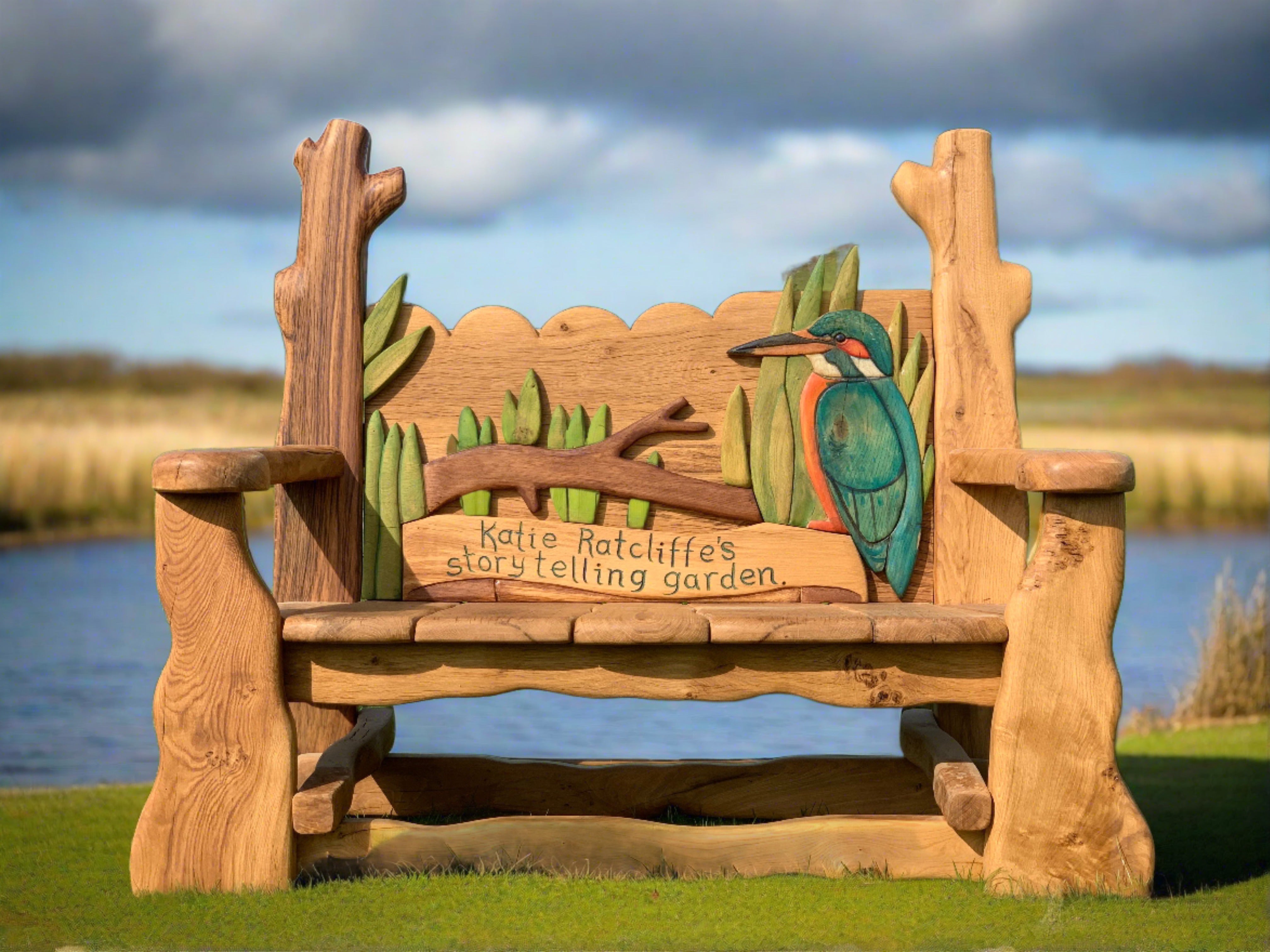 Kingfisher-themed wooden bench by lakeside