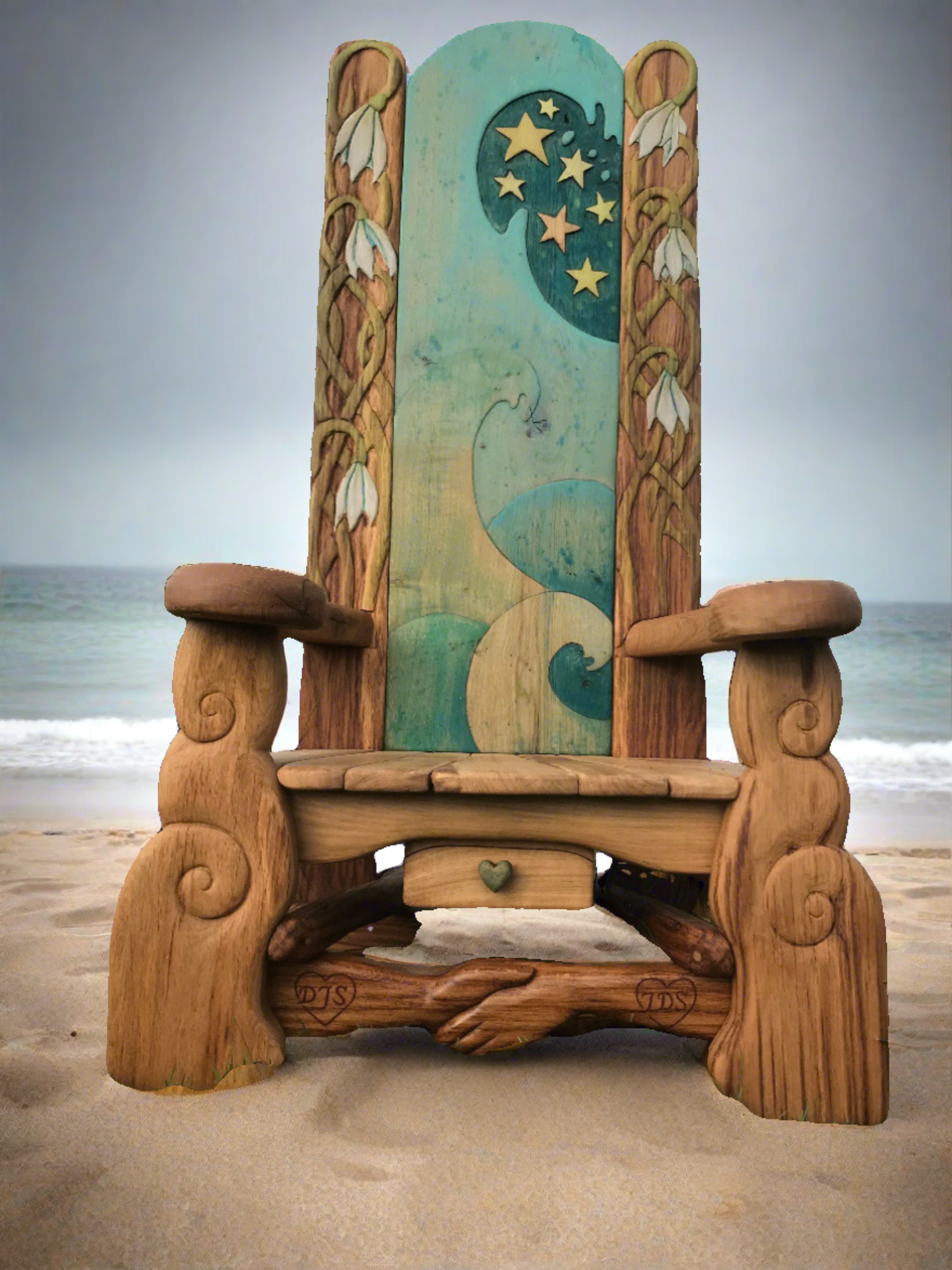 Wooden chair with ocean-themed carvings on beach