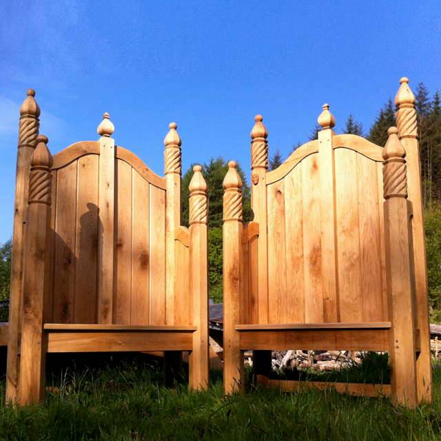 Pair of ornate carved storytelling chairs on grass