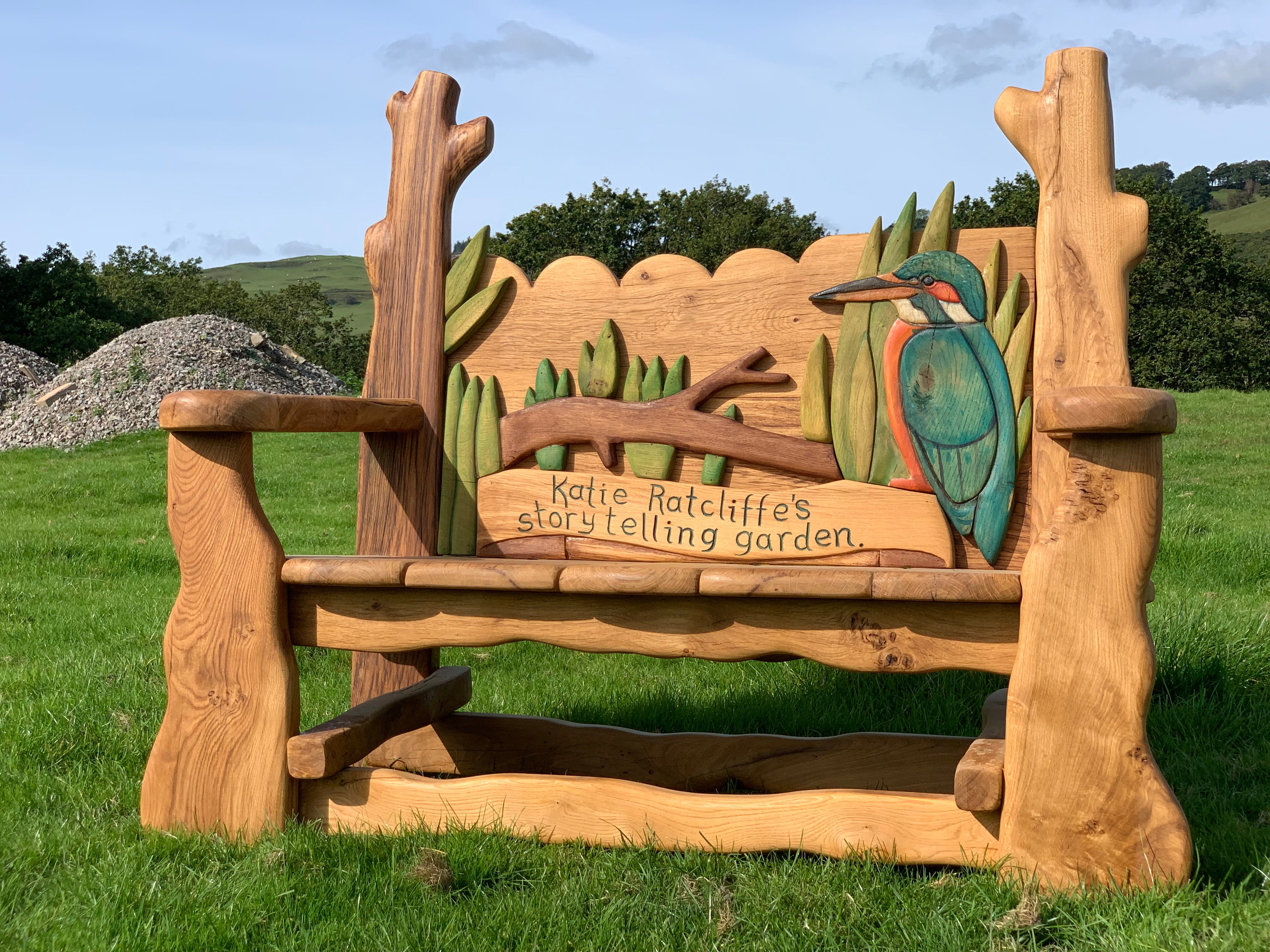 Rustic oak bench with kingfisher and storytelling garden design