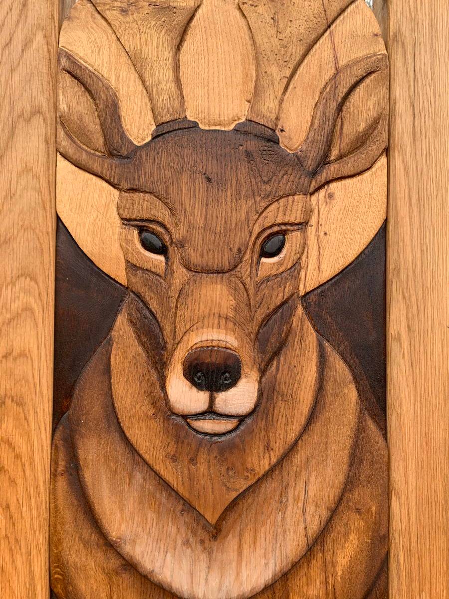 Close-up of stag carving on chair