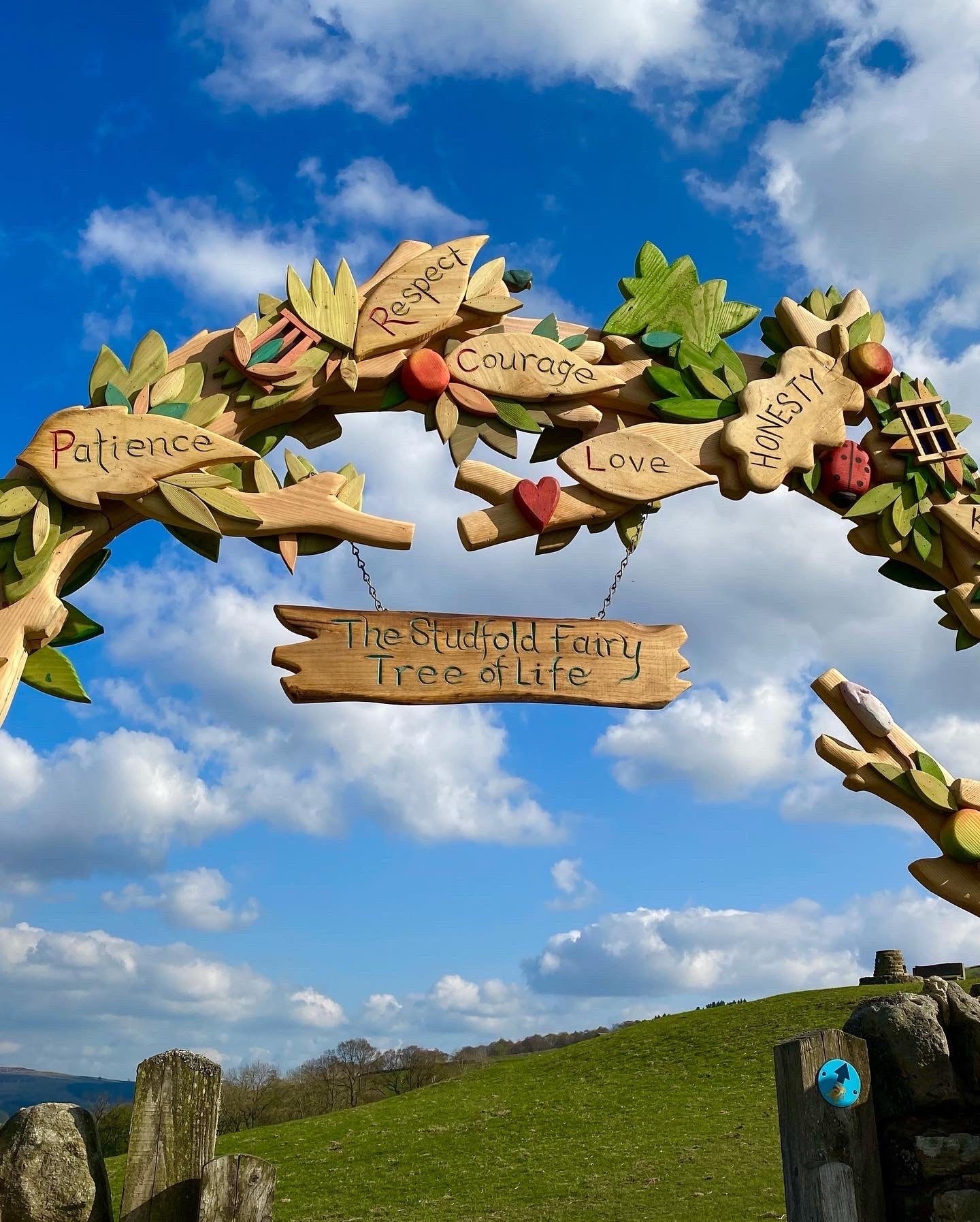 Close-up of wooden archway with words like respect and courage